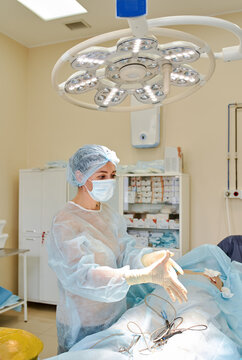 female doctor performs breast augmentation surgery for a woman