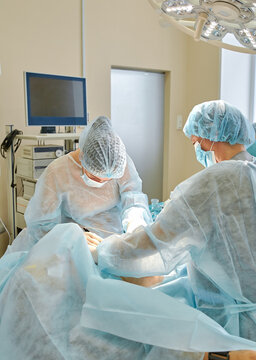 female doctor performs breast augmentation surgery for a woman