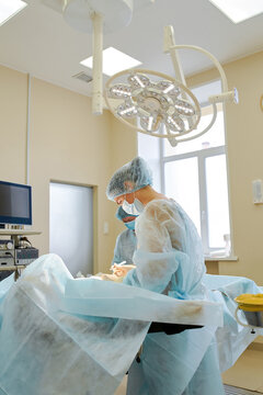 female doctor performs breast augmentation surgery for a woman