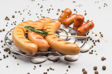 Grilled sausages on metal grill.