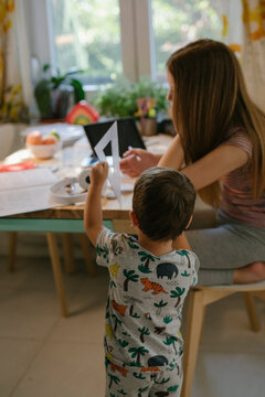 Little boy distracting his sister while doing homework