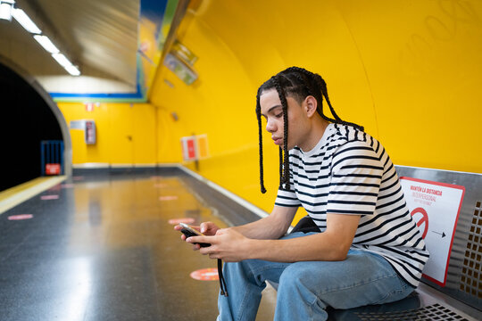 Boy Texting In The Metro.