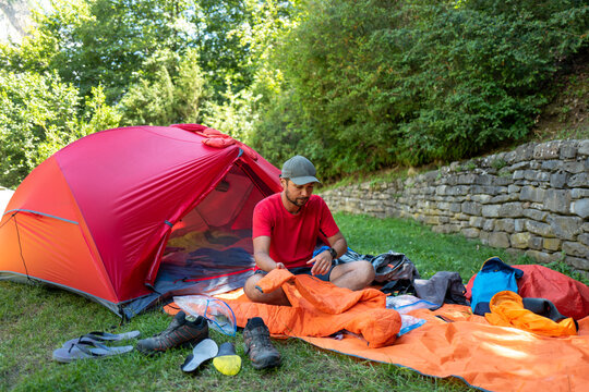 Male hiker setting up for camping