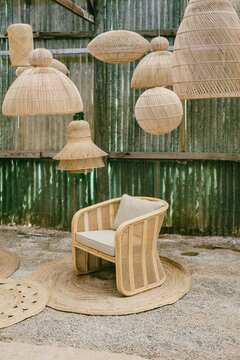 wicker armchair surrounded by lamps