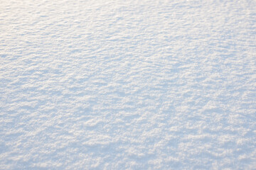 Fresh clean white snow background texture. Winter background with frozen snowflakes and snow mounds. Snow lumps. Seasonal landscape details. Cold weather.