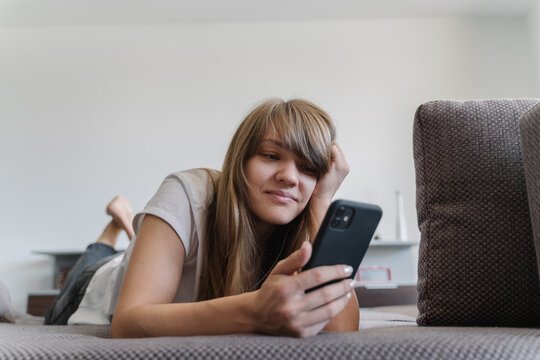 Woman With Cellphone At Home