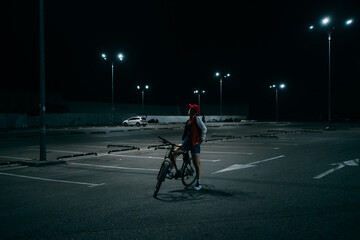 Young woman on bicycle at the parking lot