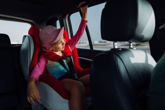 A little girl in a car