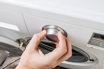 washer front panel close up. person switch appliance program mode. washing machine control panel
