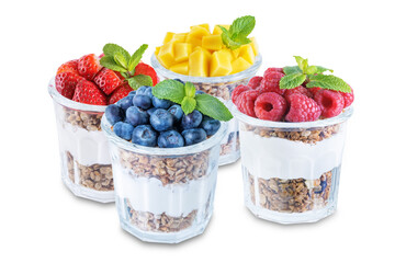 Set of Greek yogurt granola parfait with strawberries, blueberries, mango fruits and raspberries in a glass on a white isolated background
