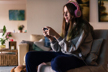 teen girl playing video games at home