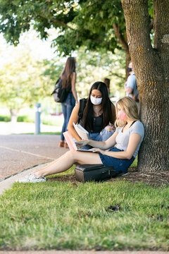 Covid: Friends Sit On Ground Taking Web Based Class