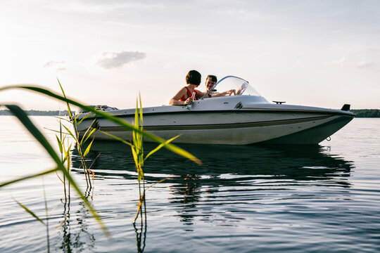 Caucasian Couple Relaxing On Boat on Warm Summer Evening