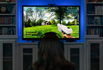 Girl Plays Modern Shooter Video Game On TV