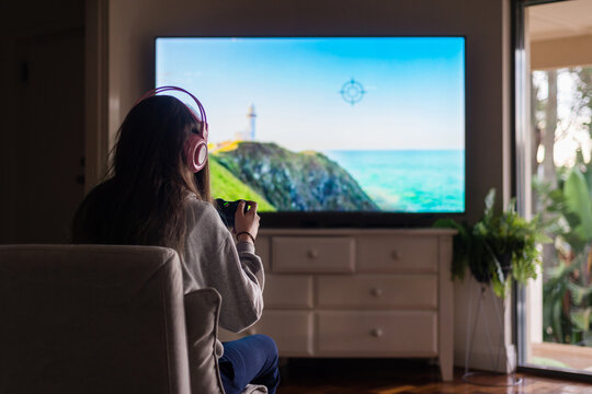 young female gamer at home