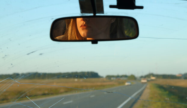 Reflection of driver in rear view mirror
