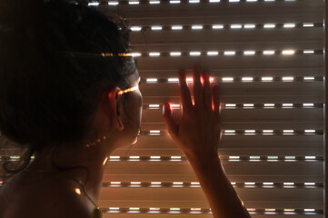 Woman watching outside through a window