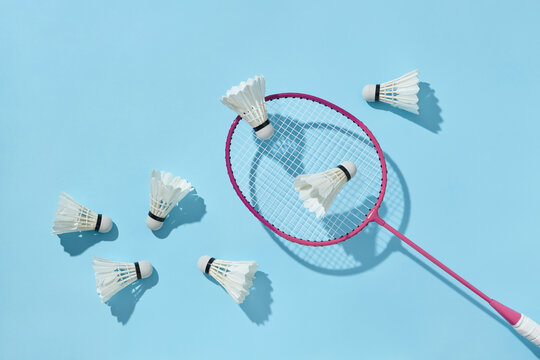 Badminton racket with feathered shuttlecocks.