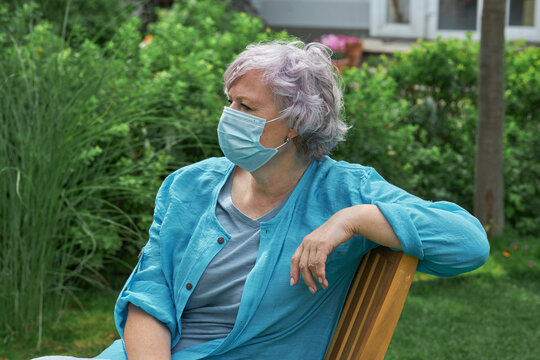 Portrait of elderly caucasian woman in mask on retirement in sunny background outdoors