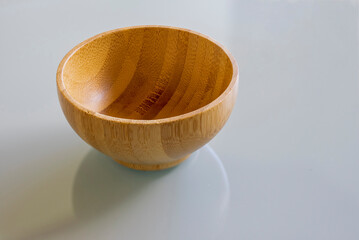 wooden bowl made of bamboo on glass table