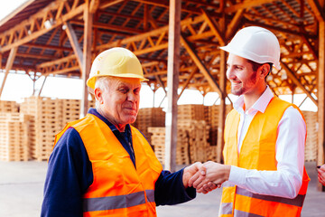 Young company manager thanks to senior foreman