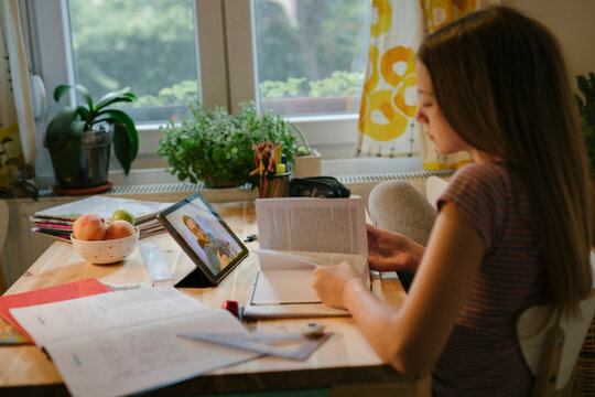 Teen Girl Watches Virtual Class From Home