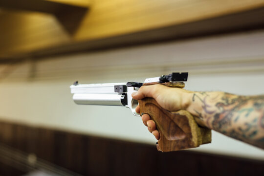 Anonymous Man Holding A Pistol