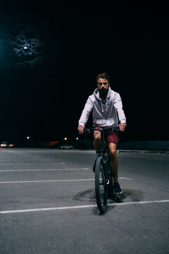 Young man on bicycle at night