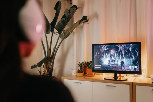 Unrecognizable woman gaming at home