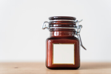 Scented candle in a glass jar on a white background