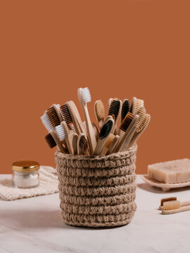 Set of bamboo toothbrushes in knitted cup