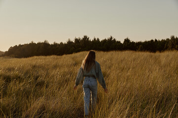Woman Walking in Field