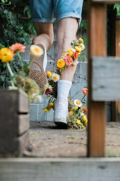 young male with flowers growing up leg