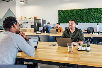 Man Smiling at a Shared Workspace