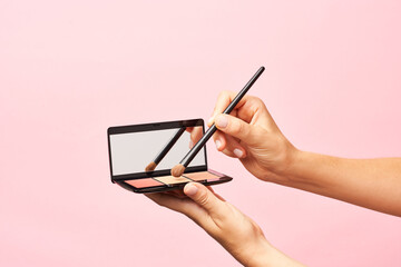 Crop person ready to apply powder