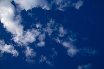 white clouds against a blue March sky, sunny day
