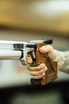 Anonymous Man Holding A Pistol