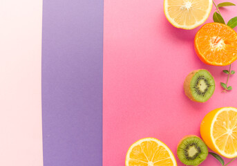 Variety of Different Tropical Seasonal Summer Fruits. Citrus Orange  Pineapple Lemons  Kiwi   on Overlapping Paper in Trendy Pastel Colors: Pink , Purple   Background. Healthy Lifestyle Diet Vitamins. - 420596062