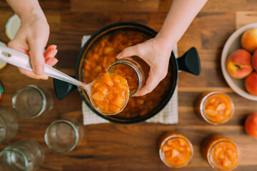 Woman preparing peach preserve