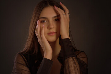 portrait of a young woman with long brown hair.