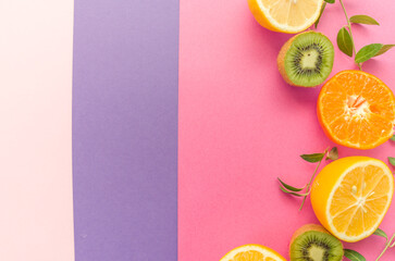 Variety of Different Tropical Seasonal Summer Fruits. Citrus Orange  Pineapple Lemons  Kiwi   on Overlapping Paper in Trendy Pastel Colors: Pink , Purple   Background. Healthy Lifestyle Diet Vitamins. - 420596410
