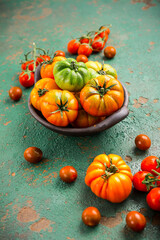 Assortment of organic tomatoes on old kitchen table