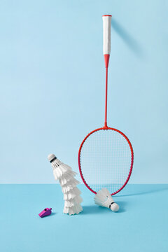 Badminton racket with feathered shuttlecocks pyramid.