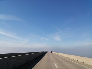 Driving in Texas Bridge with a blue sky