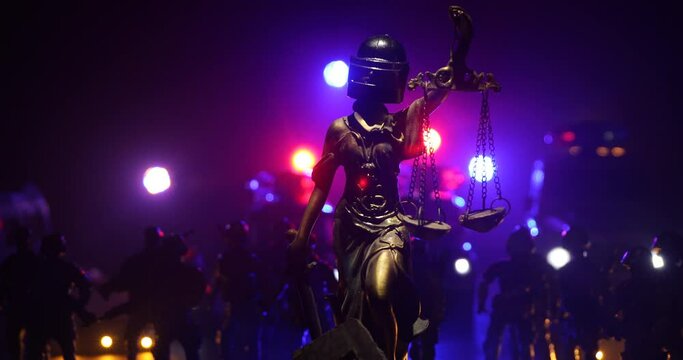 No law or dictatorship concept. The Statue of Justice with anti-riot police helmet holding scale. Creative artwork decoration with colorful toned foggy background. Selective focus