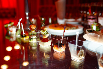 buffet table with toasts and snacks and desserts in red tones