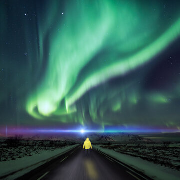 Surreal northern lights road scene