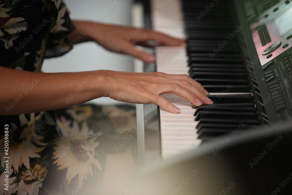 Canvas Prints close-up of a music performer's hand playing the piano , piano keyboard background with selective fo