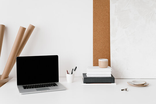 Laptop and stationery on table