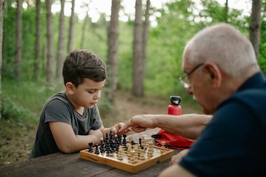 Grandfather playing chess with his grandson